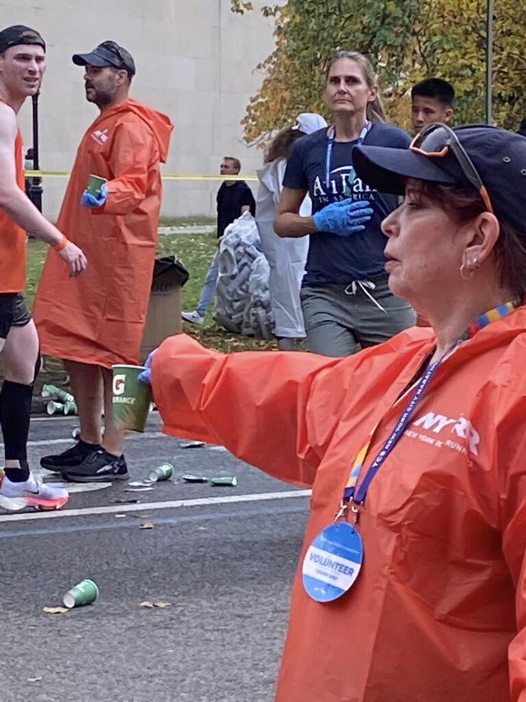 Volunteering, handing out refreshments at a marathon.