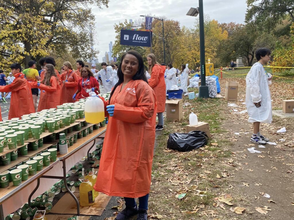 Volunteering, handing out refreshments at a marathon.